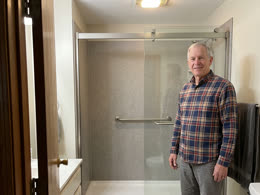 A homeowner in his remodeled bathroom