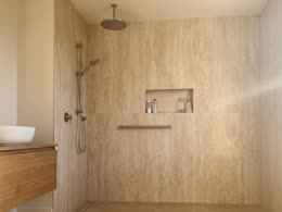 Walk-in shower in warm travertine