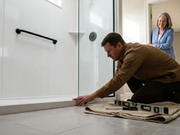 An installer setting the low threshold at floor level